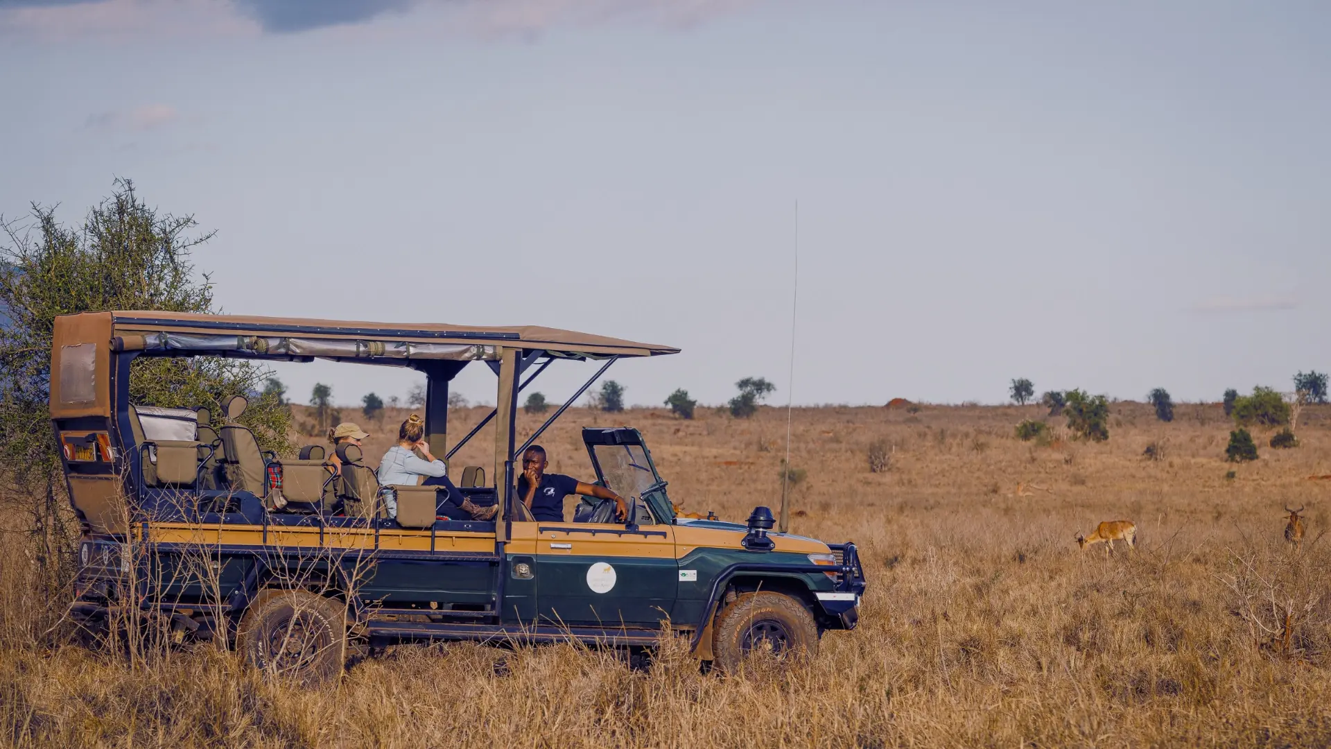 Safari vehicle on a game drive in the Lumo Conservancy
