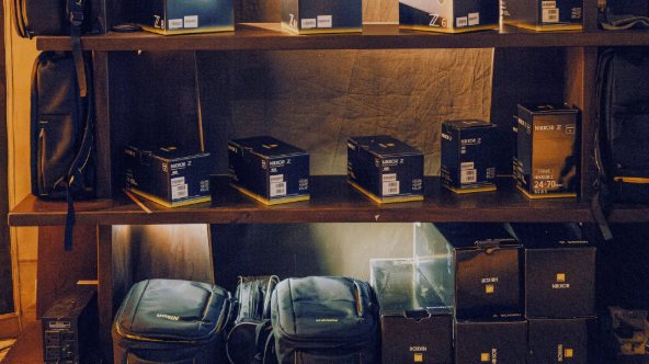 Shelves of camera lenses, boxes and bags